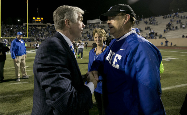 Duke Director of Athletics Kevin White shares a moment with head coach David Cutcliffe and his wife, Karen, after the Blue Devils’ victory against Miami.