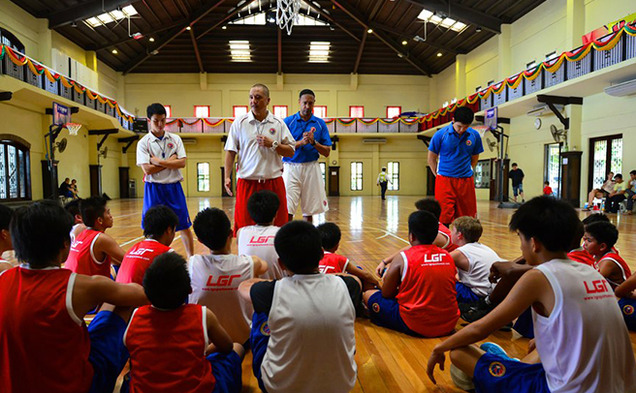 Phil Henderson, in the blue shirt at center, spent the final year of his life in the Philippines opening and running a basketball camp for kids from five to 18 years old. This caption originally said Chris Henderson. The Chronicle regrets the error.