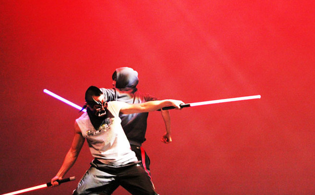 Two students perform comedic martial arts with lightsabers at the Lunar New Year celebration in Page Auditorium Saturday night.