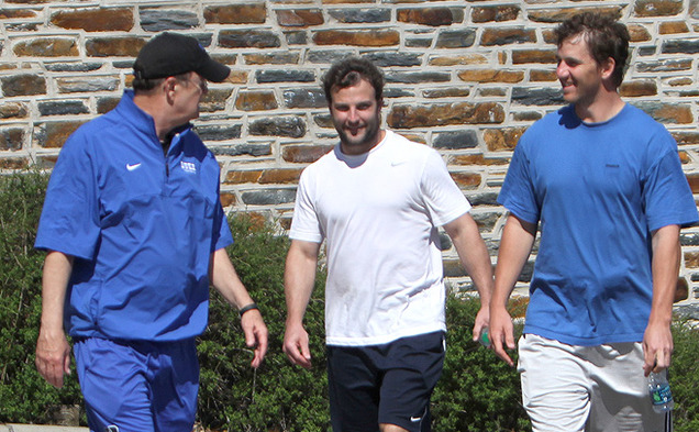 NFL stars Eli Manning and Wes Welker walk with Duke head coach David Cutcliffe outside the Yoh Football Center. Peyton Manning was close behind.