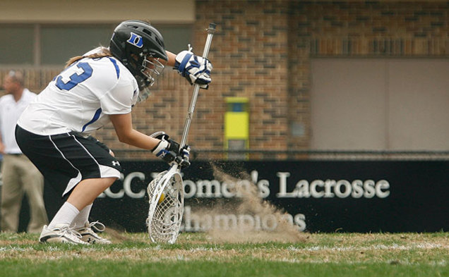 Blue Devil freshman goalie Kaitlin Gaiss scoops a low shot as sand kicks up in her face during Duke’s 19-10 rout of Navy Sunday afternoon.